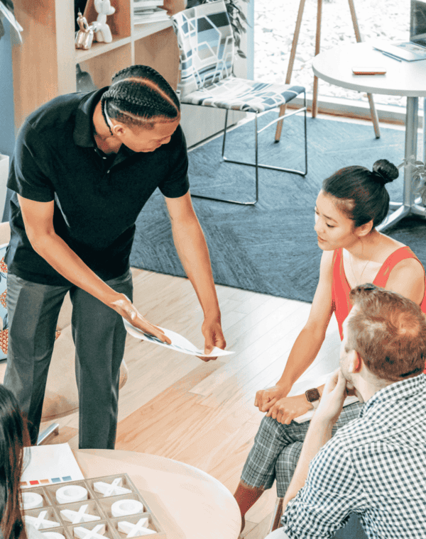 Man showing a lady a sheet of paper
